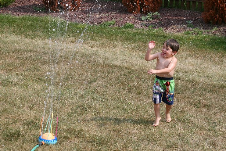 Playing in the sprinkler 1